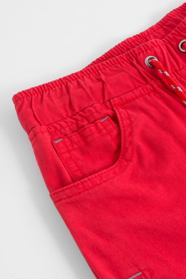 Spodnie tkaninowe w kolorze czerwonym z kieszonką na nogawce 2148123