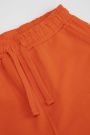 Spodnie dresowe pomarańczowe z nadrukiem na nogawce o fasonie SLIM 2222452